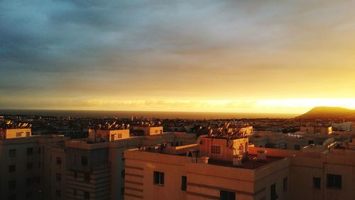 High angle shot of townscape against sky at sunset