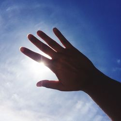 Low angle view of hand against sky
