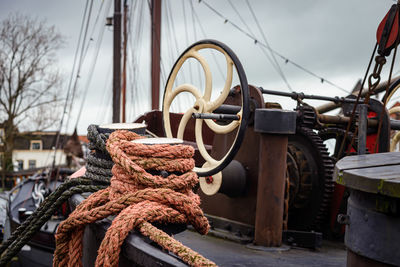 Close-up of rope tied to bollard at harbor