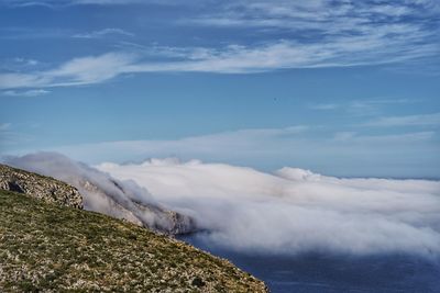 Scenic view of sea and mountains against sky