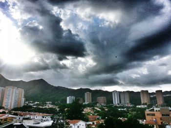 Buildings against cloudy sky