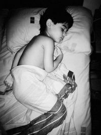 Woman lying on bed at home