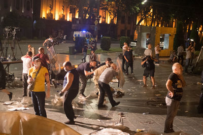 Group of people on street in city at night