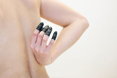 Close-up of woman hand over white background