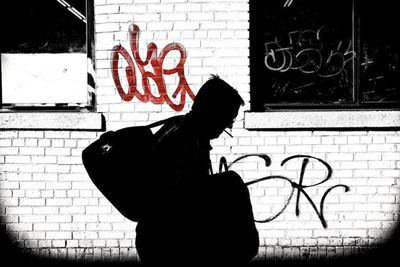 Woman standing by wall