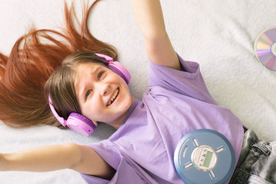 High angle view of girl lying on bed at home