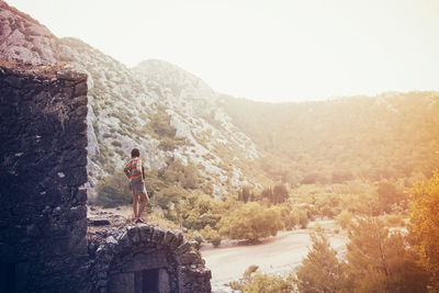 Man standing on mountain against clear sky