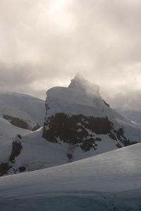 Scenic view of mountains against sky during winter