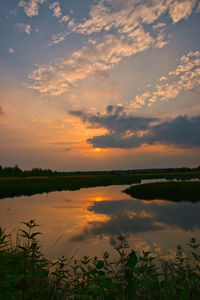 Scenic view of lake against sky during sunset
