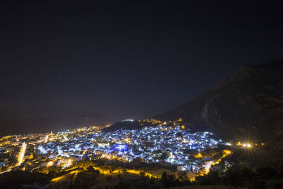 High angle view of illuminated buildings in city at night