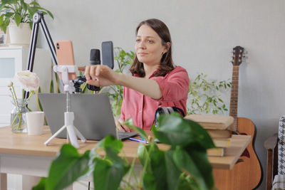 Portrait of young woman working at home