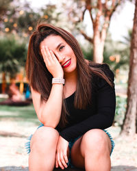 Portrait of a young woman sitting outdoors