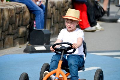 Boy driving quad bike, four wheel cycle car, spring brightly morning, sunny day