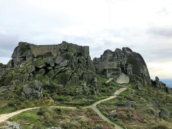 Rock formations on landscape against sky