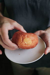 Cropped hand of person holding food