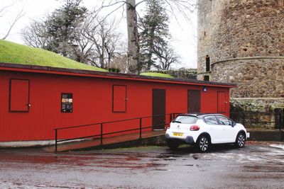 Red car parked against building