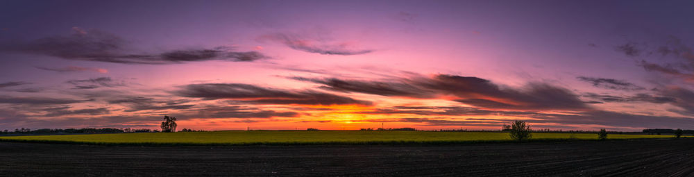 Scenic view of field against romantic sky at sunset