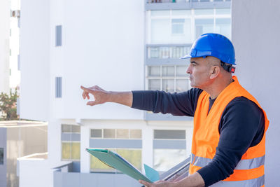 Side view of man using digital tablet in office