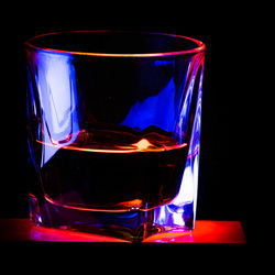 Close-up of beer glass against black background