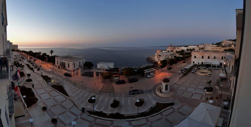 High angle view of buildings by sea against sky