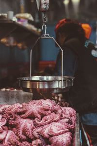 Midsection of woman preparing food at market stall