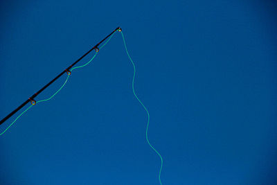 Low angle view of lightning against clear blue sky