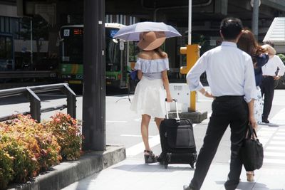 Rear view of women walking on walkway