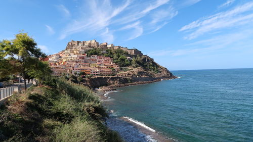 Scenic view of sea and buildings against sky