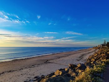 Scenic view of beach against blue sky