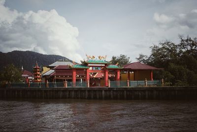 Built structure on lake against buildings