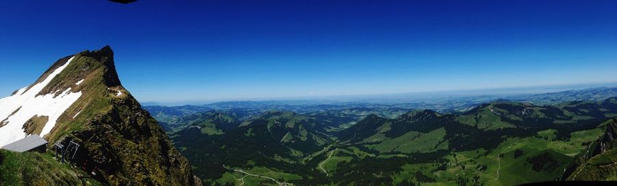 Scenic view of mountains against blue sky