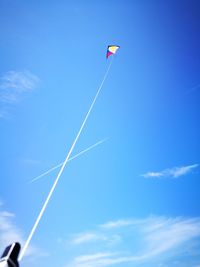 Low angle view of kite flying against blue sky