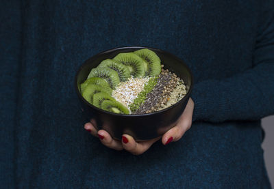 Midsection of woman holding breakfast in bowl