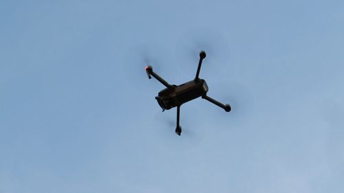 Low angle view of drone against clear sky