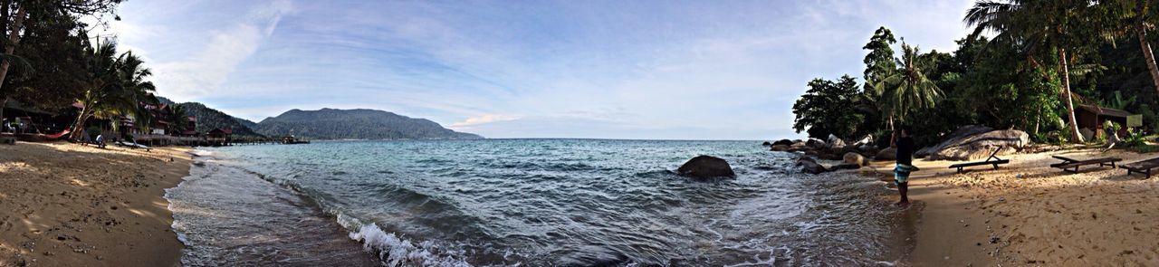 water, sea, sky, beach, tranquil scene, scenics, beauty in nature, tranquility, shore, nature, horizon over water, cloud - sky, rock - object, sand, tree, cloud, coastline, idyllic, panoramic, rock formation