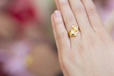 Close-up of woman hand wearing golden ring