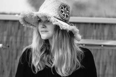 Thoughtful woman wearing hat while looking away outdoors