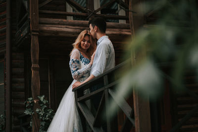 Couple standing at cottage