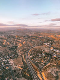 High angle view of city buildings against sky during sunset