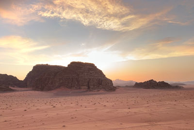 Rock formations in desert during sunset