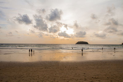 Scenic view of beach against sky during sunset