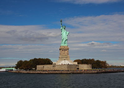 Statue of liberty against cloudy sky