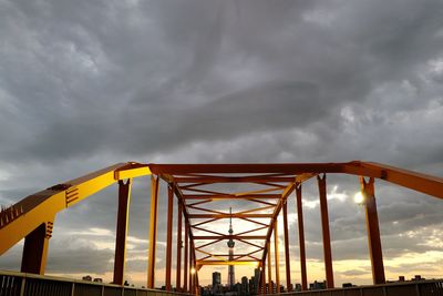 Illuminated arch bridge by tokyo sky tree against cloudy sky at dusk