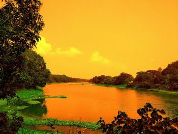 Scenic view of lake against orange sky