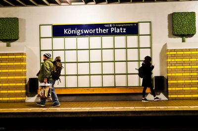 People walking on railroad station platform