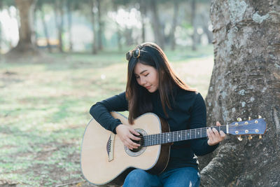 Young woman playing guitar