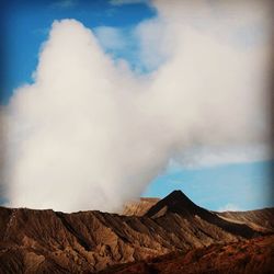 Scenic view of mountains against cloudy sky