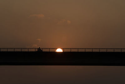 Silhouette bridge against sky during sunset