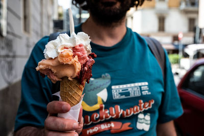 Close-up of hand holding ice cream cone