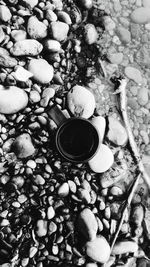 High angle view of tea cup on pebbles